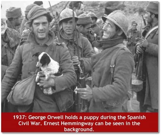 George Orwell holds a puppy during the Spanish Civil War in 1937. Ernest Hemmingway can be seen in the background