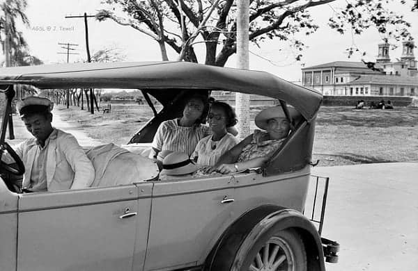 Three ladies riding an automobile in Intramuros, 1930s