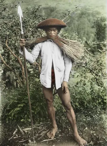 A Tinggian tribesman wears a waterproof cape made of plaited straw.