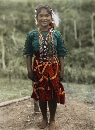 A young Ilongot woman smiles for a portrait