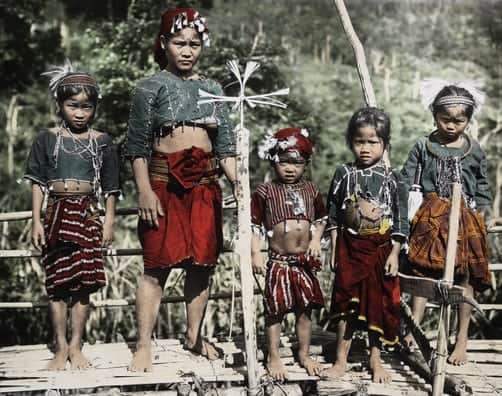 Ilongot woman and girls pose on a bamboo platform
