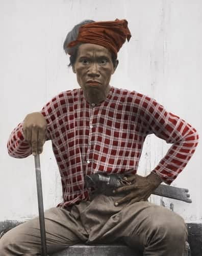 Tagakaolo man in traditional garb holding knife at waist